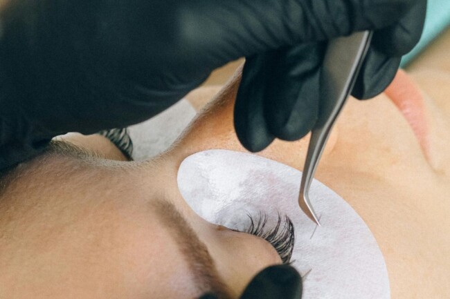 a technician works on a client's eyelashes