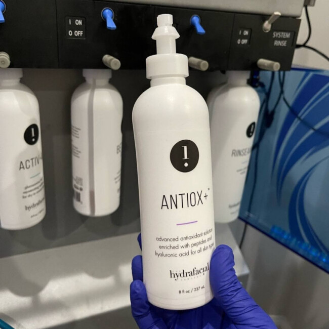 Antiox bottle in gloved hand