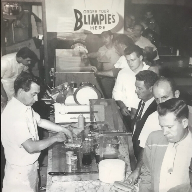 Black and white vintage Blimpie picture of men at deli counter