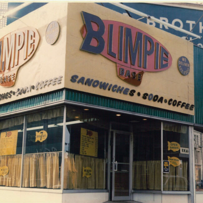 Vintage picture of a Blimpie store with a red blimp logo 