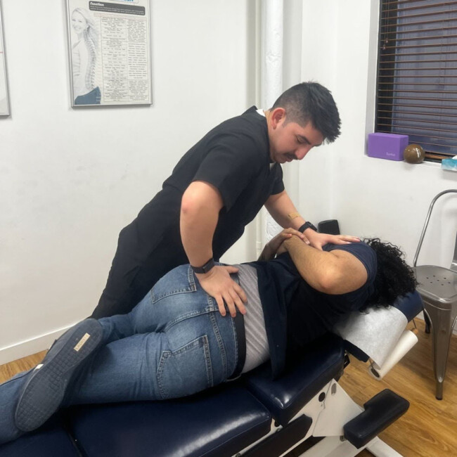Provider conducting chiropractic treatment on patient