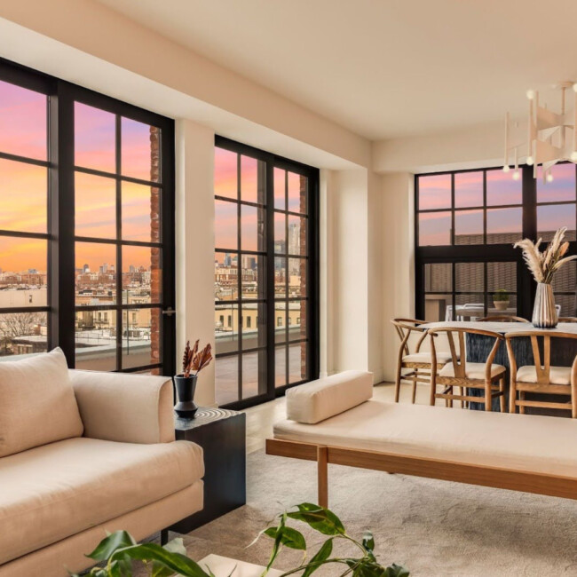 Living room sunset view with couch and large windows