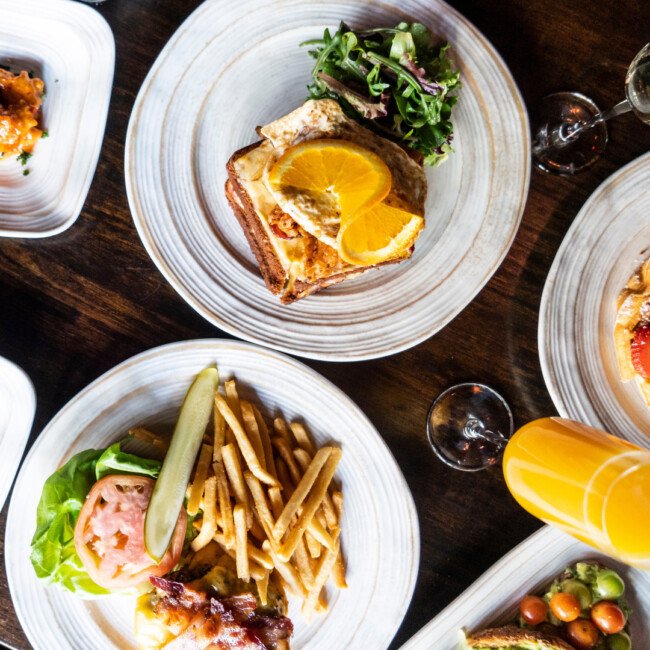 Aerial view of Six26 Brunch dishes with mimosa