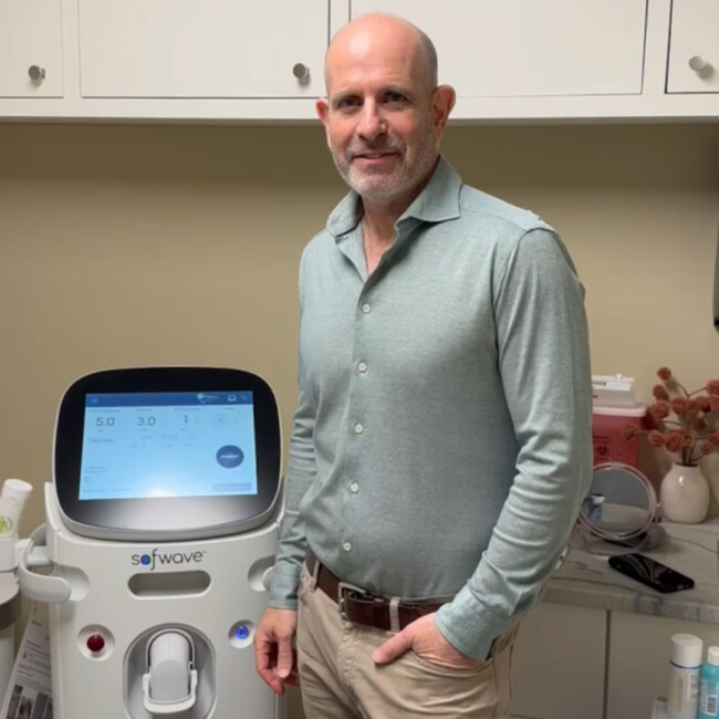 Dr. Robert Strell standing in front of the SofWave machine