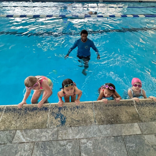 COMPASS swimming instructor and four students in a pool