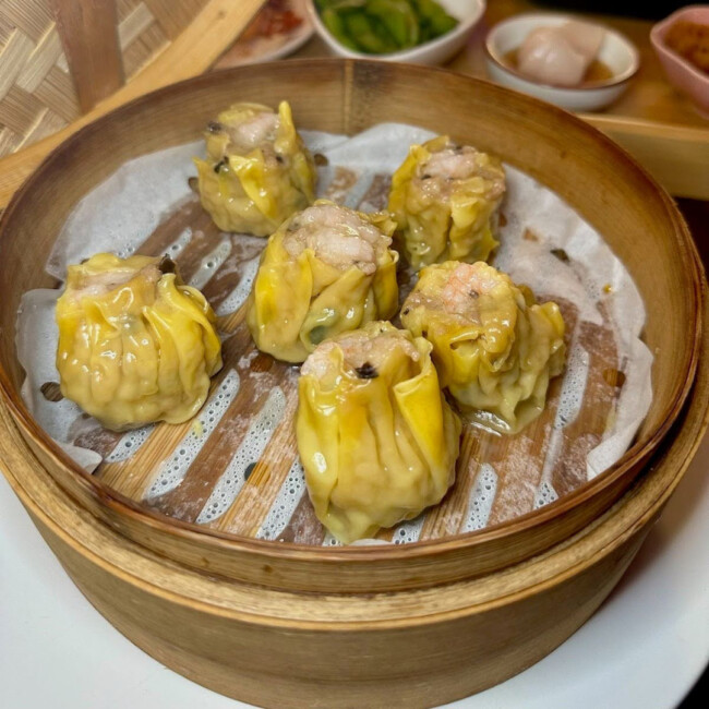 Five pork dumplings in a steamer basket