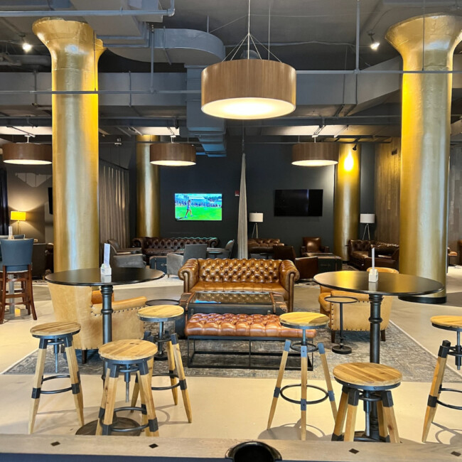 Empty interior view of The District with couches and barstools